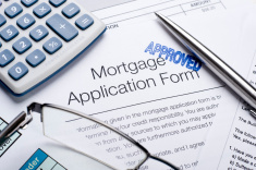 stock-photo-11948516-approved-mortgage-application-form-with-a-calculator-and-pen